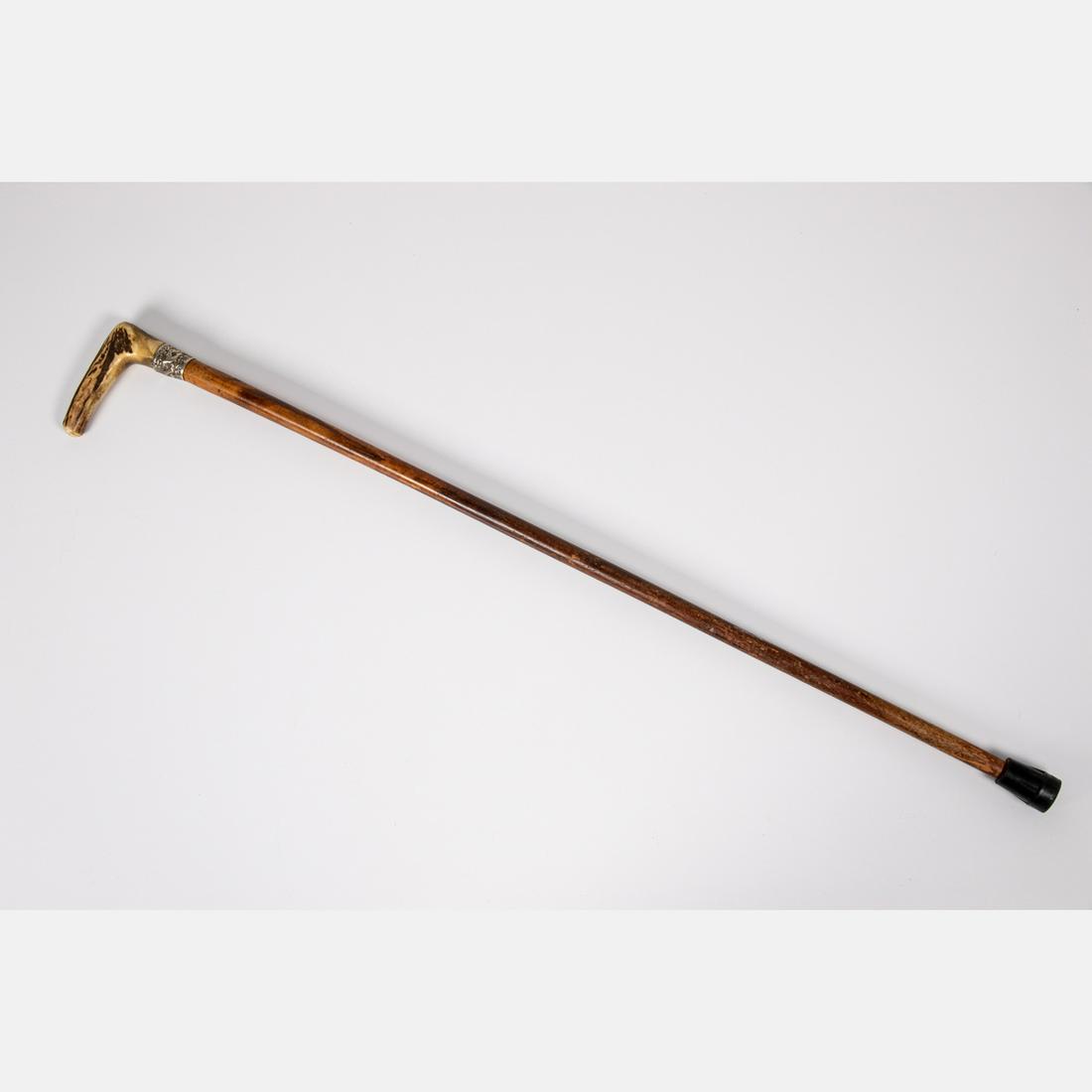 An Antler and Hardwood Walking Stick, 19th Century,: An Antler and Hardwood Walking Stick, 19th Century, Having a silverplated embossed collar. L: 35 1/4 in.