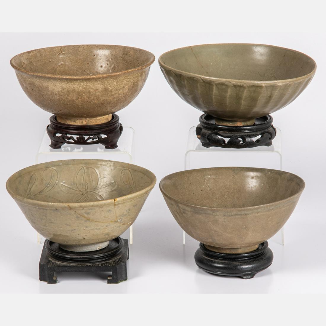 A Group of Four Korean Celadon Bowls,: A Group of Four Korean Celadon Bowls, 20th Century, Having carved hardwood stands. Largest dimension: dia: 8 in.