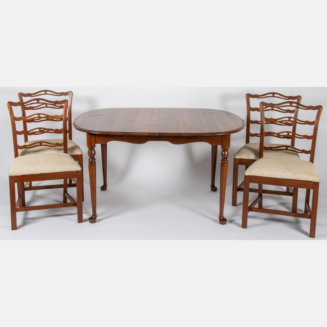 A Chippendale Style Mahogany Dining Table and Four: A Chippendale Style Mahogany Dining Table and Four Chairs, 20th Century. Table dimensions: H: 29 x W: 69 D: 42 in. Chair dimensions:H: 35 x W: 19 x 17 in.