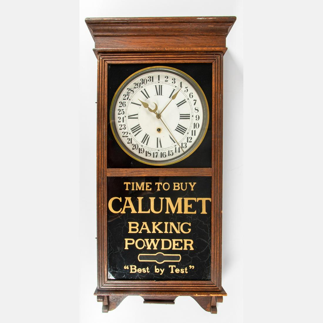 Sessions Clock Co. Advertising Wall Clock: A Sessions Clock Co. Advertising Wall Clock, 20th Century,With oak case and reverse painted Calumet Baking Powder Sign. With pendulum and key.H: 38 1/2 W: 16 1/2 D: 4 3/4 in.The Falls-Wyse Collection