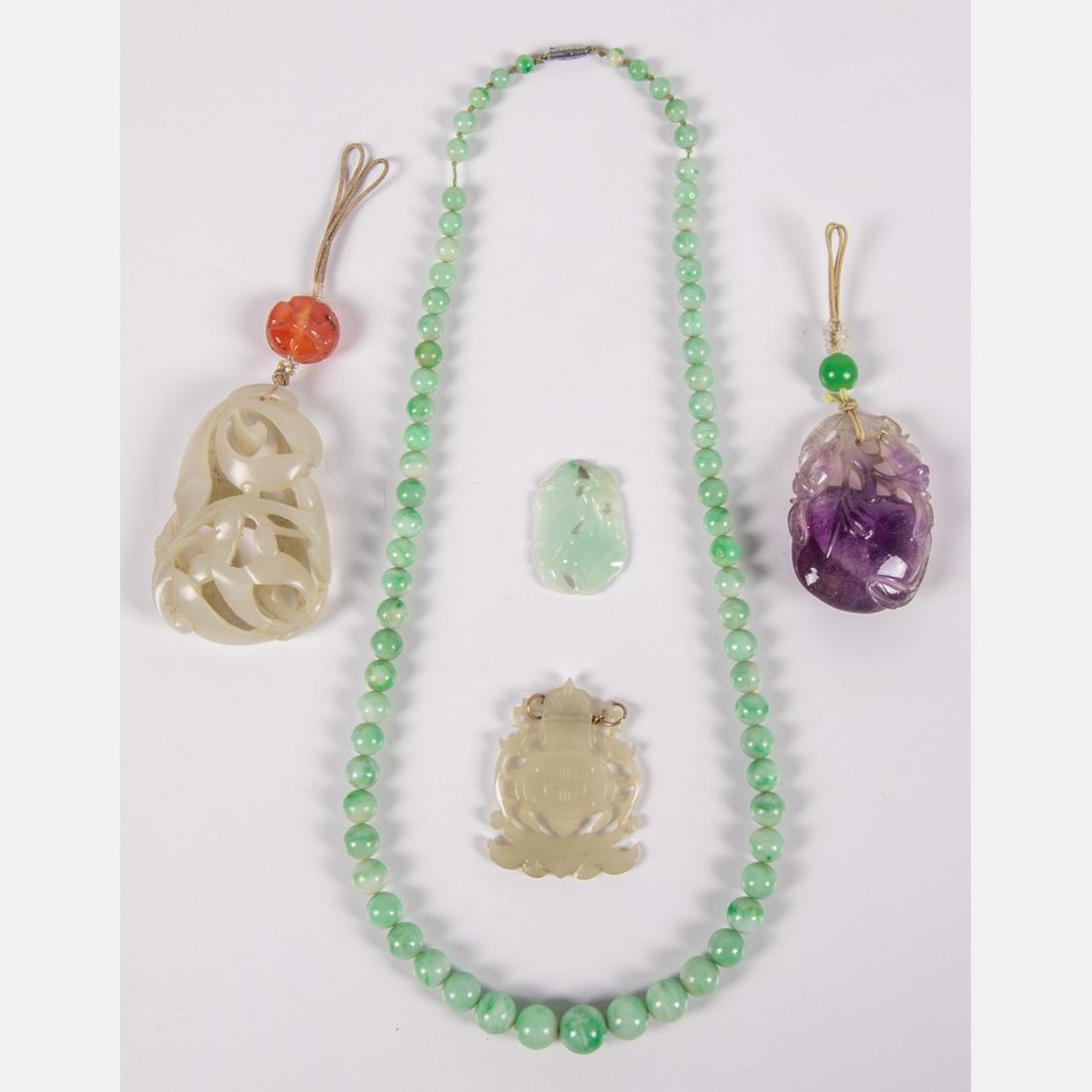 A Collection of Chinese Carved Jade and Quartz Pendants: A Collection of Chinese Carved Jade and Quartz Pendants and Beaded Necklace, 20th Century.Please note no credit card payments for first time buyers and seven business day hold on all checks.