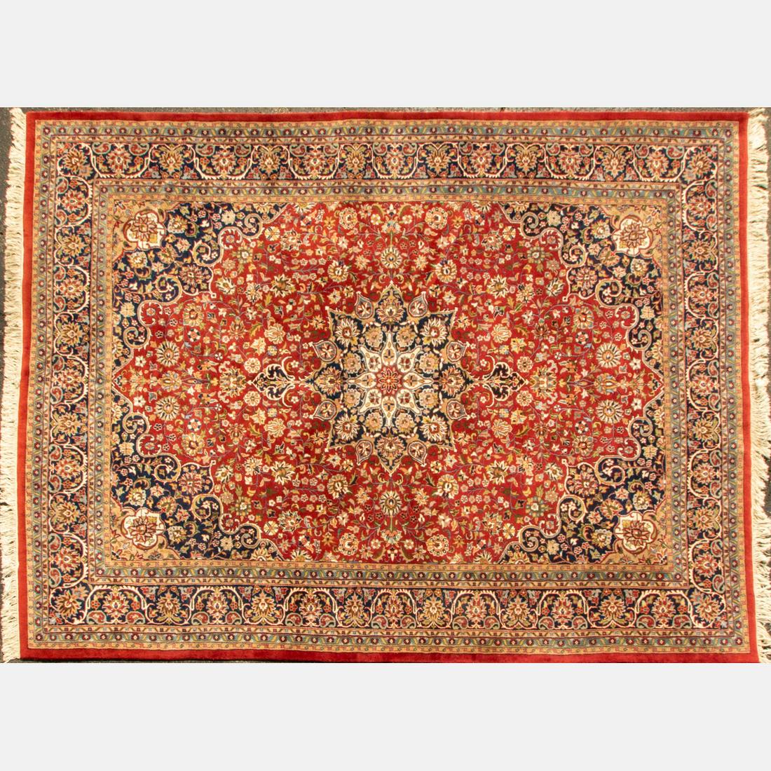 A Persian Mashad Wool Rug, 20th Century. (1 of 4)
