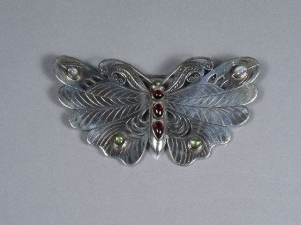 A Sterling Silver Garnet, Peridot and Moonstone Bu: A Sterling Silver Garnet, Peridot and Moonstone Butterfly Brooch, Stamped 925.