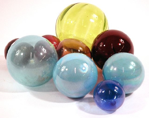 A Collection of Nine Colored Glass Witches Balls.: A Collection of Nine Colored Glass Witches Balls.