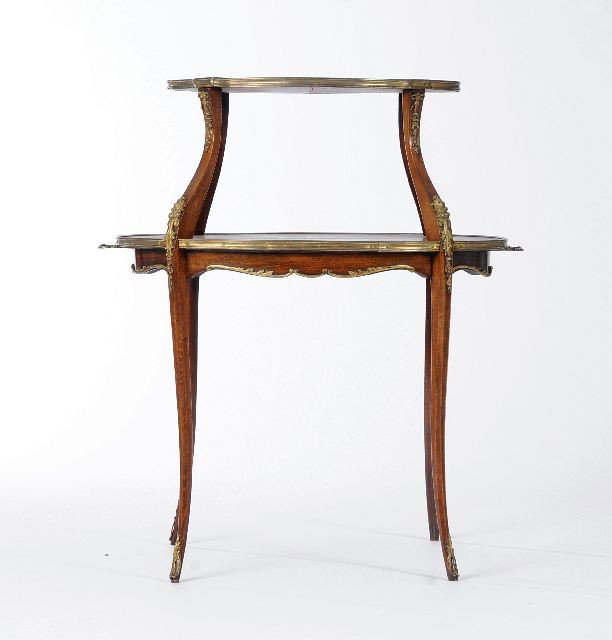 A Louis XV Style Mahogany, Brass and Marble Two Ti: A Louis XV Style Mahogany, Brass and Marble Two Tier Guéridon, 20th Century, with a shaped marble-top raised on saber supports, above marquetry inlay table, above tapering saber legs with brass ornam