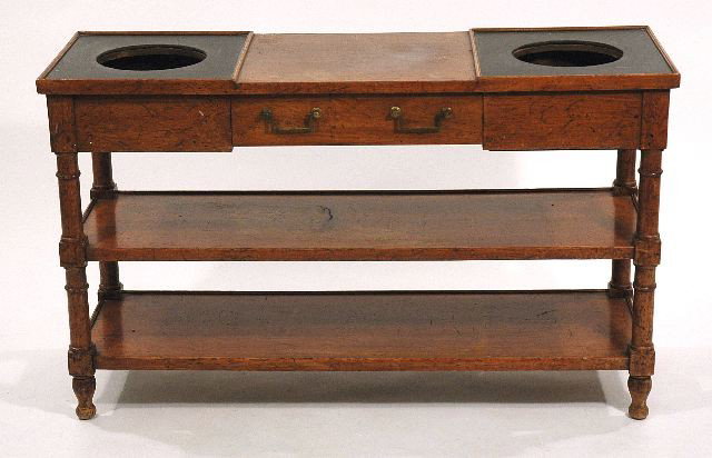 A Georgian Style Mahogany Diminutive Serving Table: A Georgian Style Mahogany Diminutive Serving Table, 20th Century, with a fitted center drawer and wine coolers. Height:27.5 Width:45 Depth:15