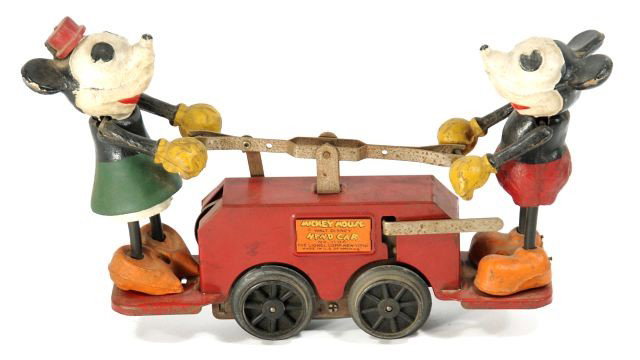 A Lionel Model Number 1100 Mickey Mouse Hand Car.: A Lionel Model Number 1100 Mickey Mouse Hand Car. Note condition: minor paint loss, lacking tails and key. Height: 5.75 Width: 10 Depth: 2