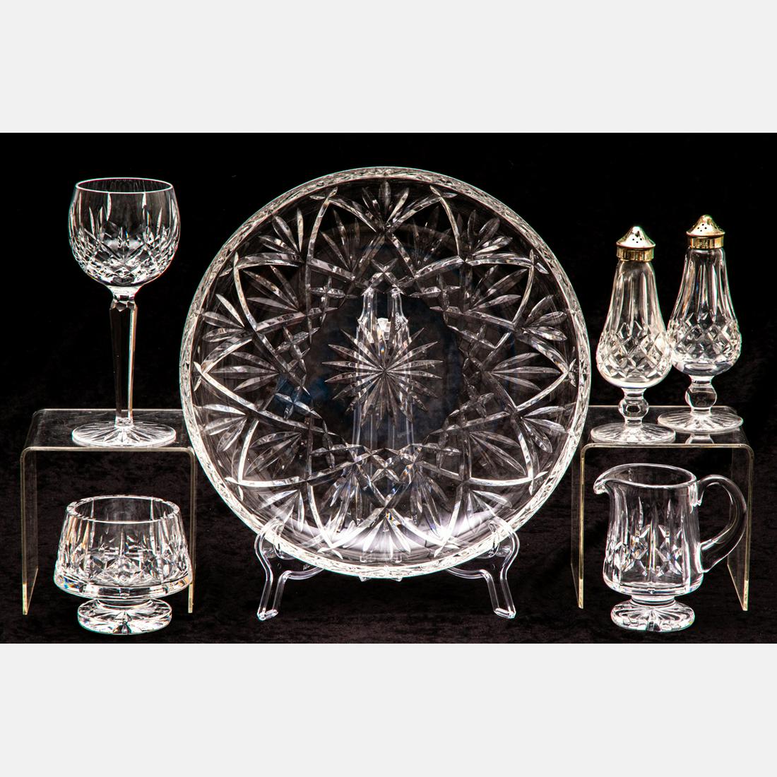 A Collection of Waterford Crystal: A Collection of Waterford Crystal, 20th Century, Comprising a 12 inch platter, a pair of salt and pepper shakers, a cream pitcher, an open sugar and a wine goblet. Platter dimension: Dia: 12 in.