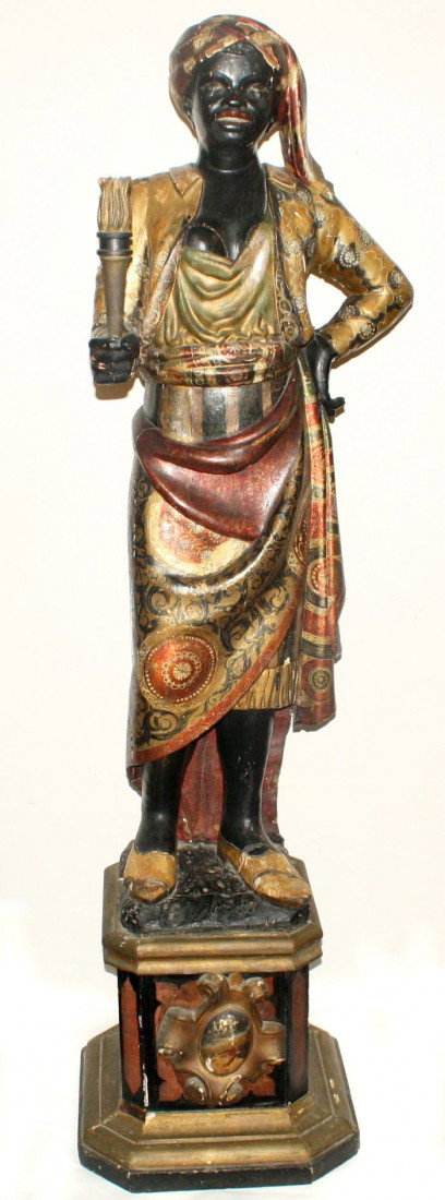 An Italian Ebonized and Parcel Gilt Blackamoor Torch