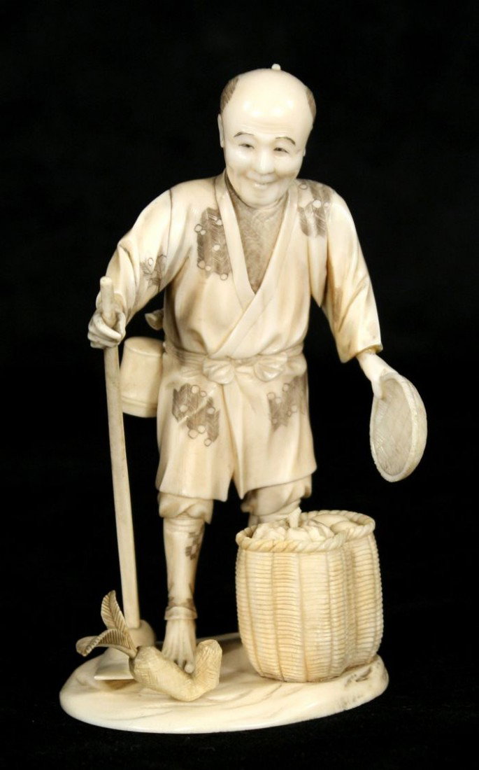 A Japanese Carved Ivory Figure of a Peasant Farmer,