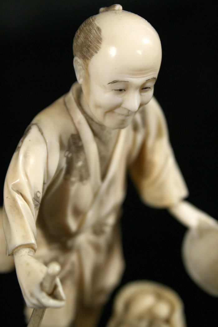 A Japanese Carved Ivory Figure of a Peasant Farmer, - 2