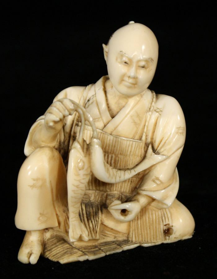 A Japanese Carved Ivory Figure of a Fisherman, Meij