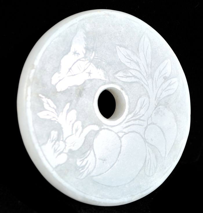A Chinese Carved White Jade Bi-disc,: A Chinese Carved White Jade Bi-disc, Having pierced center surrounded by raised floral and butterfly motifs. Diameter: 2.25 inches.