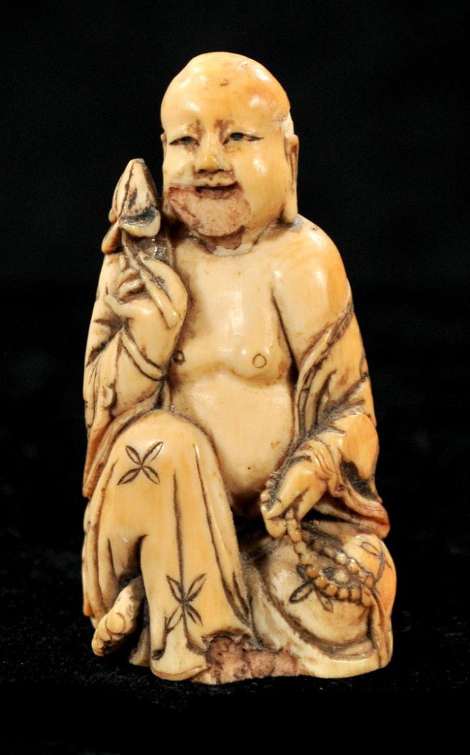 A Carved Ivory Netsuke: A Carved Ivory Netsuke, Depicting a seated monk. Signed on base by artist. h: 2.50 in.