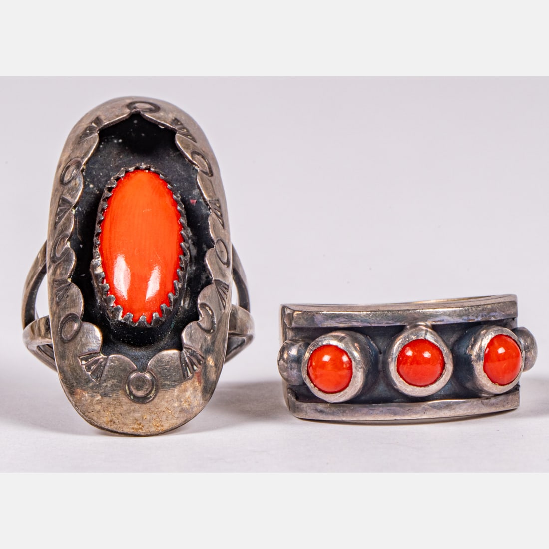 Two Navajo Silver and Coral Rings: Two Navajo Silver and Coral Rings, Each unsigned. Sizes: 6 and 7 1/2 Approx. weight: 0.42 troy oz.