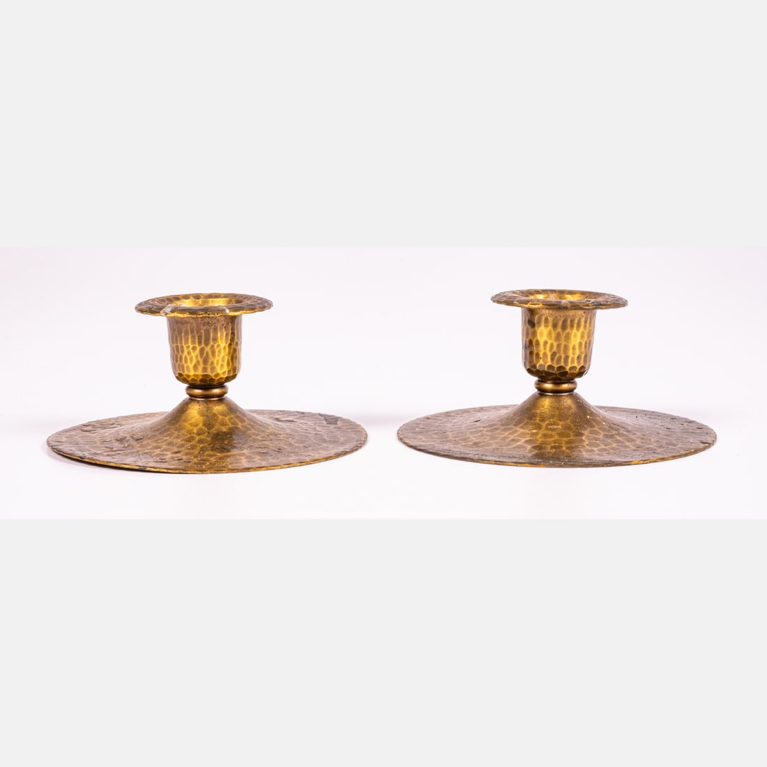 Pair of Hammered Copper Candlesticks: A Pair of Hammered Copper Candlesticks, With maker's mark. H: 2 D: 4 in.