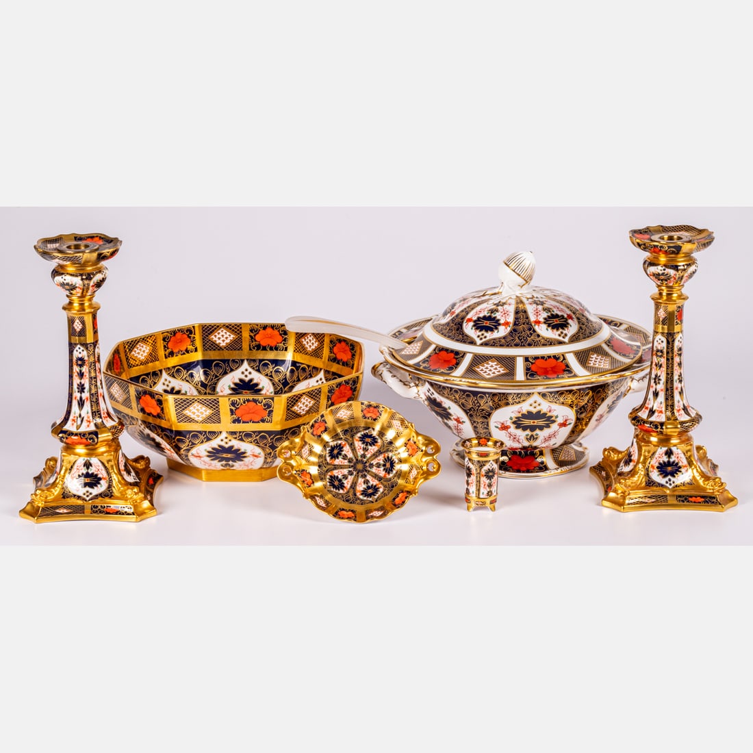 Royal Crown Derby Old Imari Pattern Bone China Serving Ware: Six Pieces of Royal Crown Derby Old Imari Pattern Bone China Serving Ware and Candlesticks, Including a 9 1/2 x 12 in. lidded tureen, a pair of repaired 10 1/2 x 5 1/4 in. candlesticks, a repaired 4 1