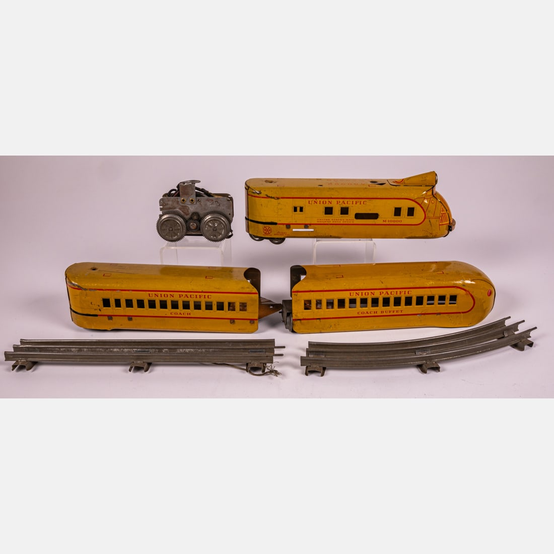 A 1930's Marx Space M-10,000 Tin Litho Union Pacific Three Piece Toy Train,: A 1930's Marx Space M-10,000 Tin Litho Union Pacific Three Piece Toy Train, Mechanical, with twelve rails. Engine dimensions: H; 2 1/2 x L: 10 1/4 x W: 2 1/4 in.