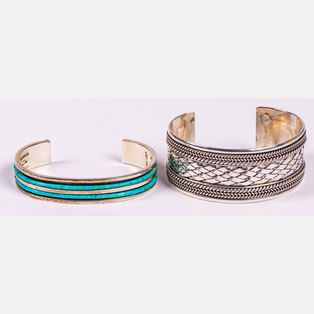 Two Sterling Silver Cuff Bracelets,: Two Sterling Silver Cuff Bracelets, Each marked Sterling 925. One having inlaid turquoise. Largest cuff: 1 1/16 in. thick Approx. total weight: 2.2 troy oz.