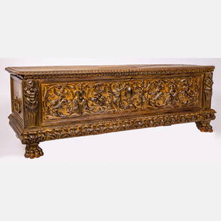 An Italian Baroque Carved Walnut Cassone: An Italian Baroque Carved Walnut Cassone, 17th/18th Century, Having carved opening top cover supported with wrought iron hinges. The front panel with male and female figural pilasters flanking carved