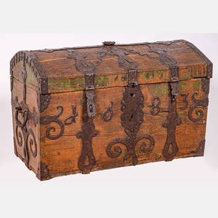 A Spanish Oak and Iron Domed Chest: A Spanish Oak and Iron Domed Chest, 17th Century, With elaborate iron work and areas of painted decoration. Dated 1683. H: 22 1/2 W: 34 D: 20 3/4 in. From the Estate of John A. Davidson, Jr.