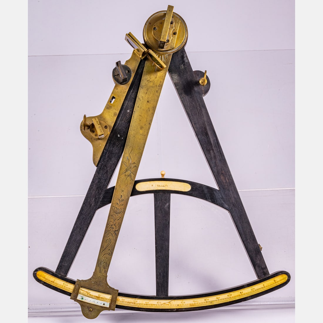 An Ebonized Wood and Bronze Octant,: An Ebonized Wood and Bronze Octant, Marked S. Braley, 19th Century, In a fitted oak case. Ebonized wood and bronze with bone inlay. Central bone plaque inscribed S. Braley. Fitted case has retailer's 
