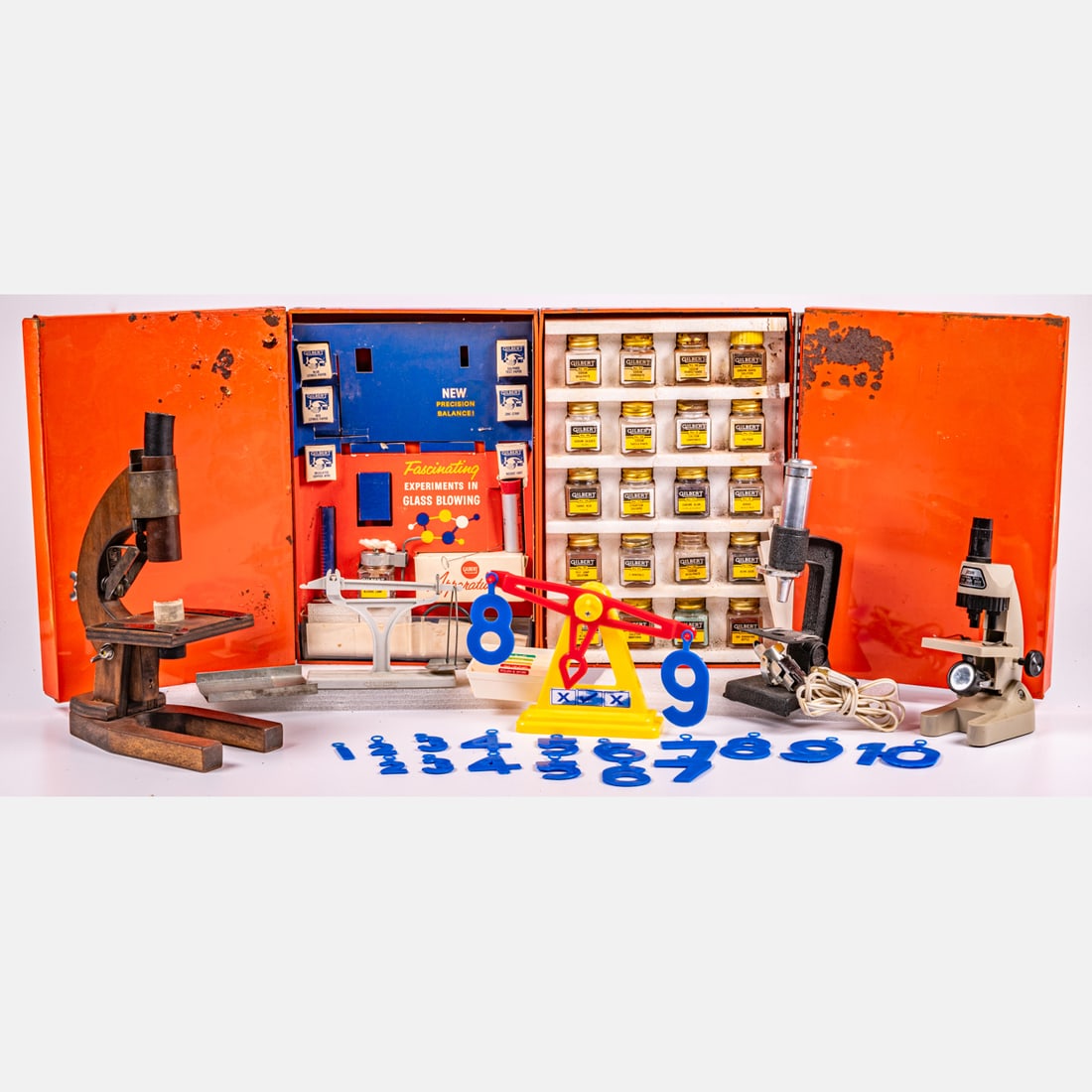 Assorted Vintage Scientific Toy Instruments: A Collection of Assorted Vintage Scientific Toy Instruments, 20th Century. Including three microscopes, two scales, jars of mineral specimens in a vintage Gilbert Chemistry Set box. Metal box dimensio