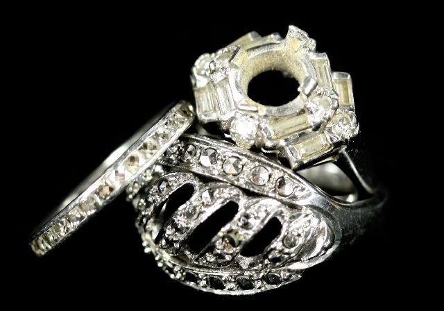 A Group of Three Diamond and Moissanite Rings.: A Group of Three Diamond and Moissanite Rings. Comprising of a 14kt. white gold and diamond eternity band, a platinum and diamond engagement ring lacking center stone and a Russian platinum plated and