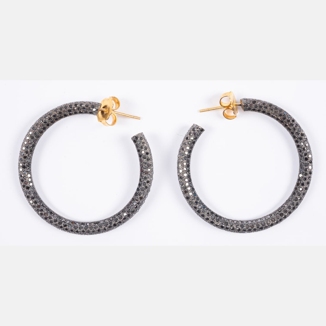 Black Diamond, 18kt & Silver Earrings: A Pair Of Black Diamond, 18kt Yellow Gold & Blackened Silver Hoop Earrings, Pave set black diamonds on blackened silver hoops. Diamonds have an approximate individual weight of 0.003 carats Posts are 