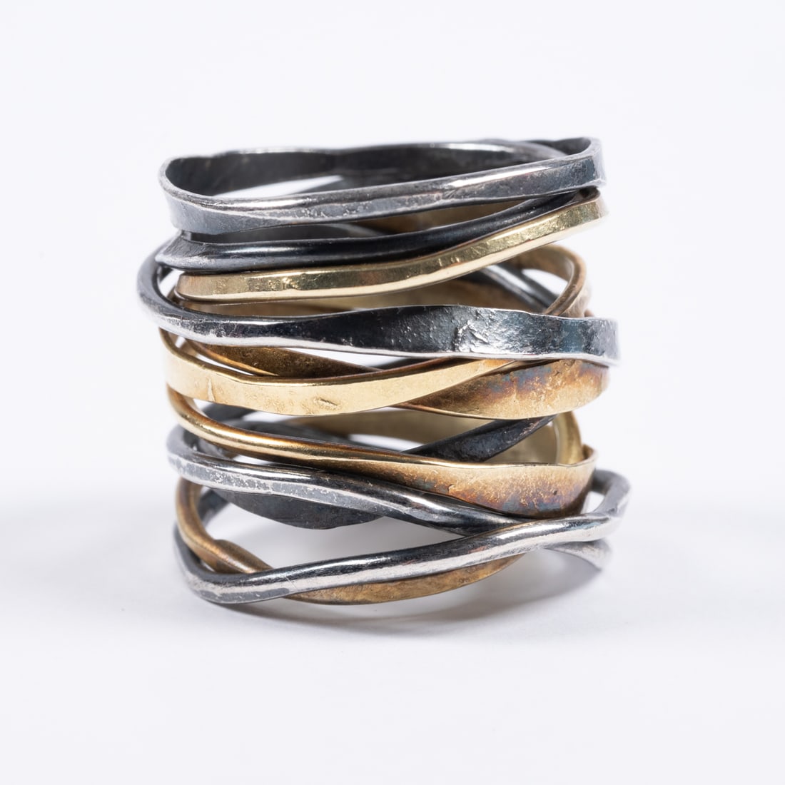 14kt Yellow Gold And Silver Wrap Ring: A 14kt Yellow Gold And Silver Wrap Ring, Hammered lengths of gold and silver wire are woven together in this artisinal ring. Unmarked, unsigned. Tests as 14kt and silver. Ring size 6 Total weight appr