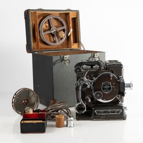 A Kodascope Model B 16mm Film Projector with Fitted Case, Extra Lenses, and Charlie Chaplin Film
