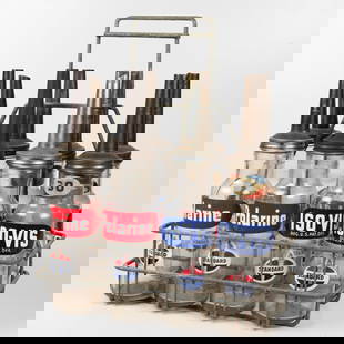 Standard Oil Glass Oil Bottles in Metal Carrier: Eight Standard Oil Glass Oil Bottles in Metal Carrier, Comprising: Four Polarine and four ISO-VIS bottles, each with metal pouring spouts, all missing caps. Overall with carrier: H: 20 in. x W: 15 1/2