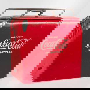 A Vintage Acton MFG Coca-Cola Ice Chest: A Vintage Acton MFG Coca-Cola Ice Chest, With two original aluminum shelf inserts, bottle opener and screw in lower drain plug. H: 19 W: 17 D: 13 in.