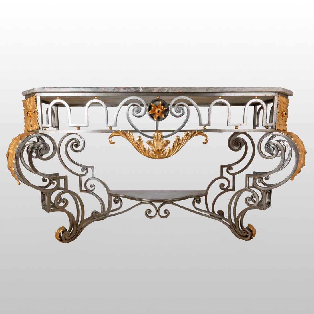Louis XV Palace Sized Console Table: A Louis XV Palace Sized Wrought Iron and Parcel Gilt Marble Top Console, 18th Century. Having grey rouge and ochre marble above a conformingly shaped geometric frieze centered by a gilt floral and lea