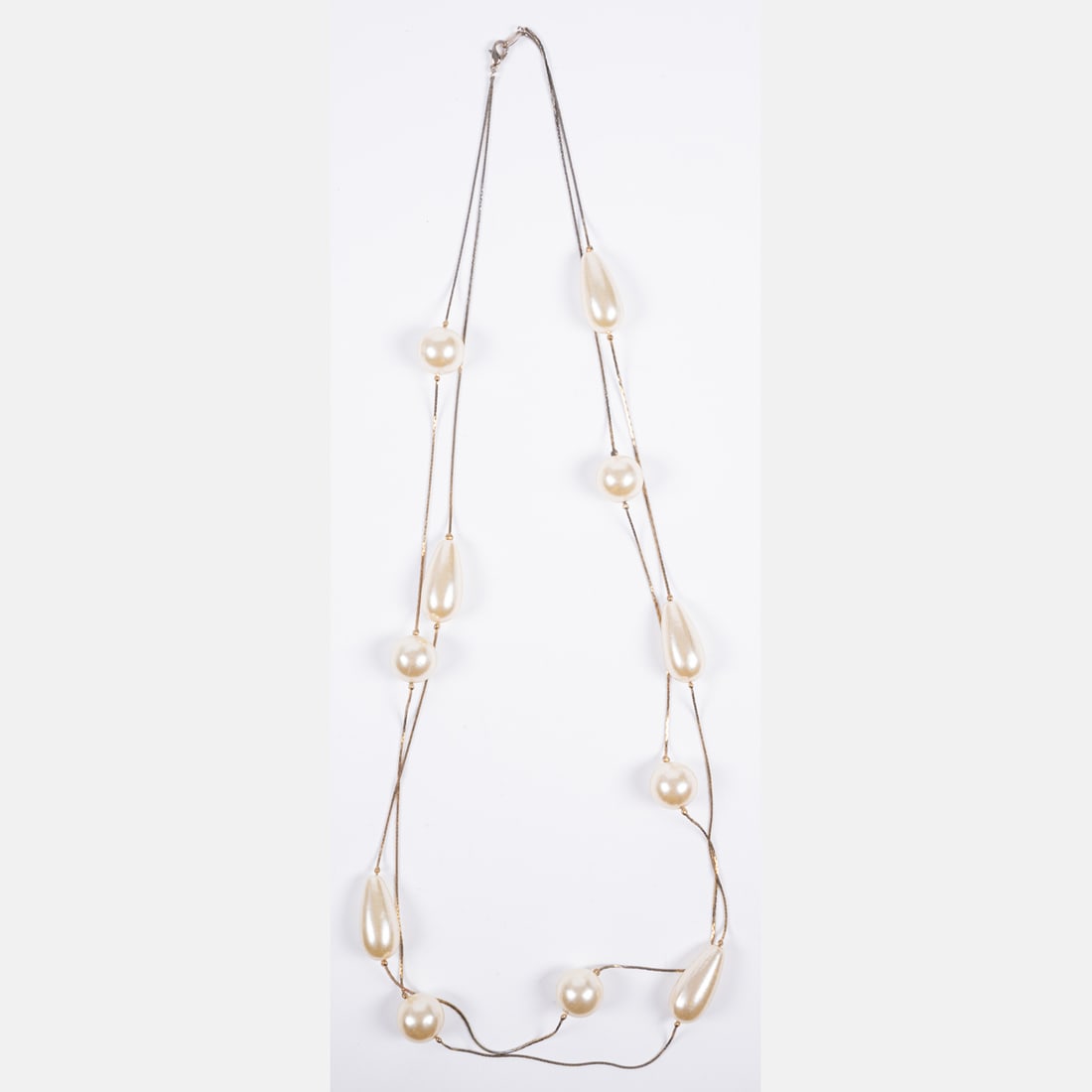 Faux Pearl And Gold Tone Chain Necklace: A Faux Pearl And Gold Tone Chain Necklace Two strand cobra-link chain accented by round and pear shaped faux pearls. Beads range in size from 16 to 28 mm Total length: 32 inches Please note no credit 