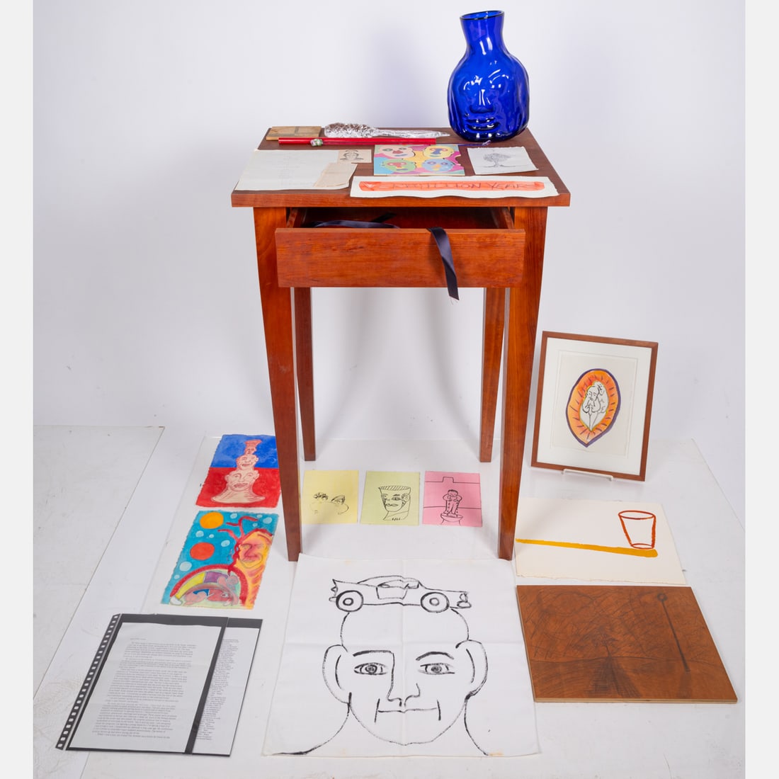 Robin Winters (American, b. 1950): Robin Winters (American, b. 1950) Vermillion years, Sculpture assemblage, cherry wood table with drawer, blown glass, drawings and paper collage, unframed drawings, puzzle pieces. Titled with correspo