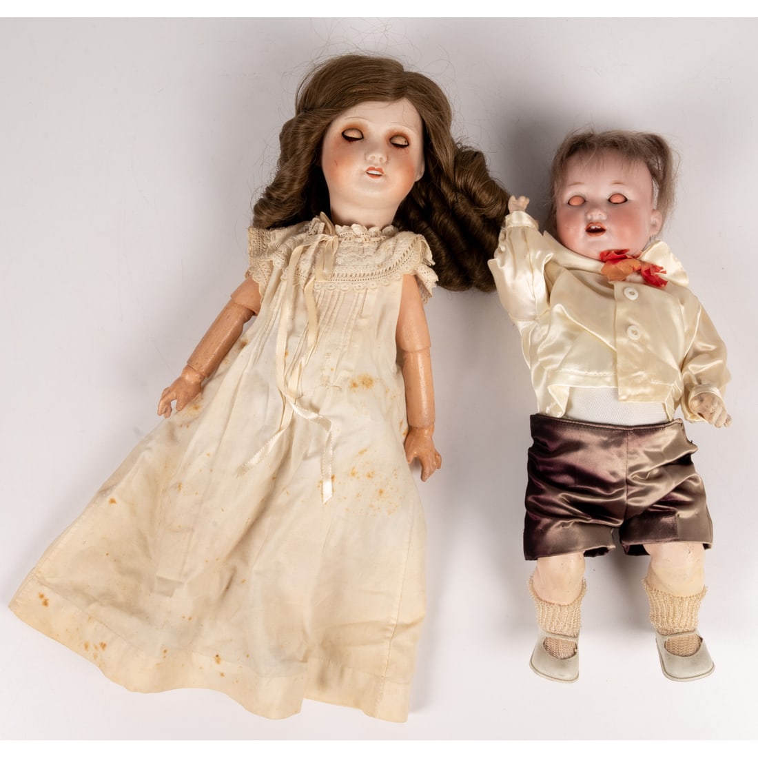 Two Bisque Porcelain Dolls: Two Bisque Porcelain Dolls, 19th Century, Comprising: Boy doll marked M 1923 Germany 3/0 Girl doll marked E.T. Both dolls have working "sleepy" eyes. Girl doll length : 13 in. From the collection of a