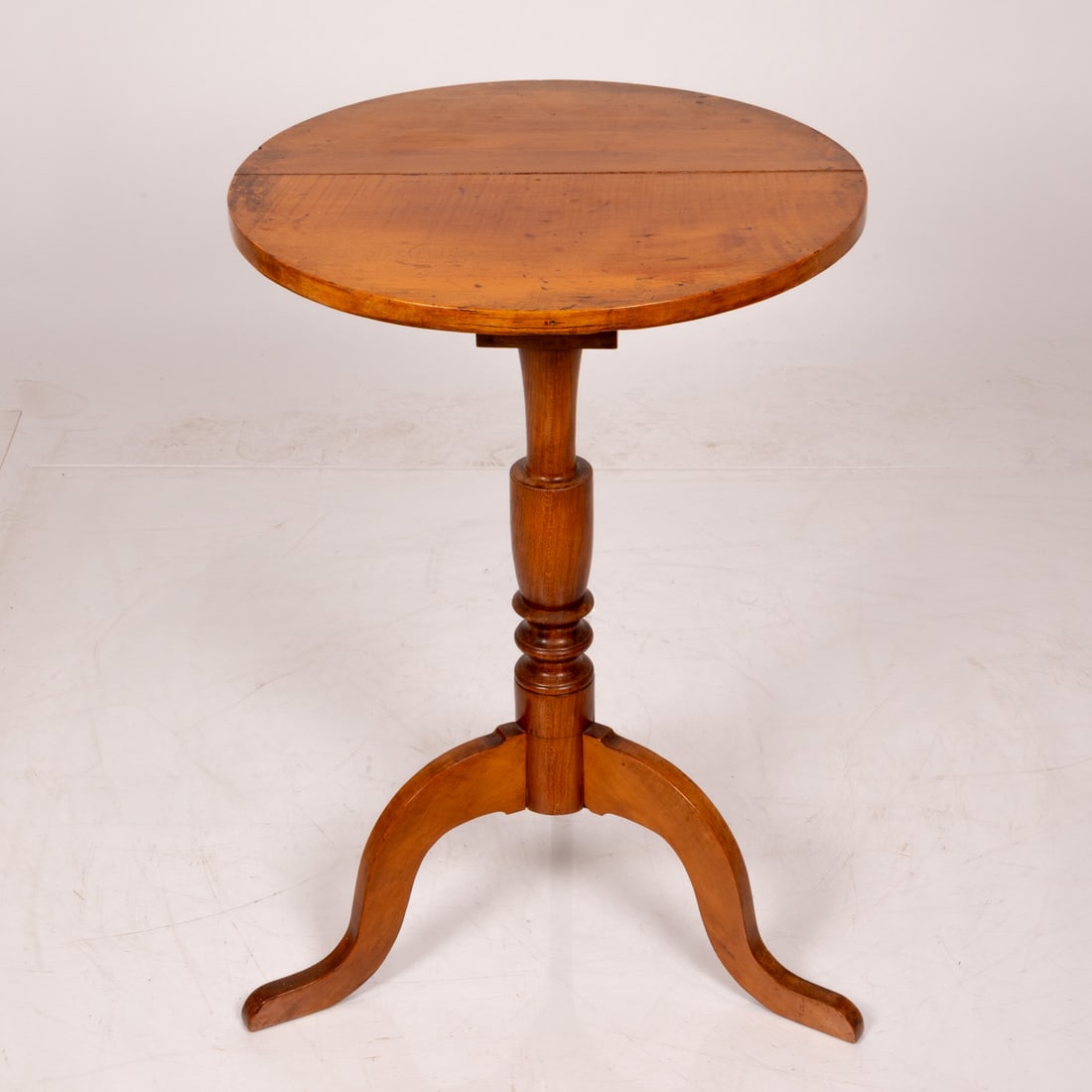 American Tiger Maple Tilt Top Tea Table: American Tiger Maple Tilt Top Tea Table, early 19th c., Having split circular top above birdcage with brass catch. H: 29 1/2 D: 20 in.