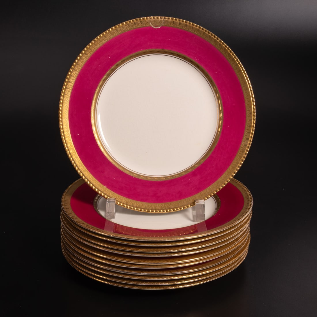 11 Booths Porcelain Dinner Plates: Eleven English Porcelain Dinner Plates by Booths, 20th Century, A white ground surrounded by a magenta border with with gilding on both sides and a modeled rim. Marked on underside "Booths Silicon Chi