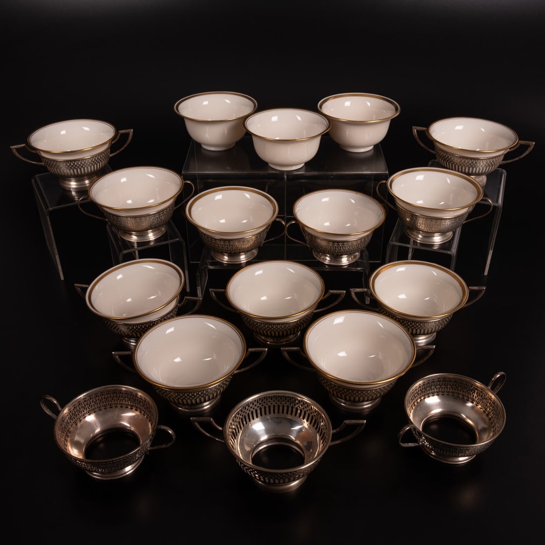 2 Sets of Lenox Boullion Soups: 14 Lenox Boullion Soups with Sterling Holders, 20th Century, Six have a double gilt rim border with a single line under the rim, with pierced holders marked International sterling. Eight have a double