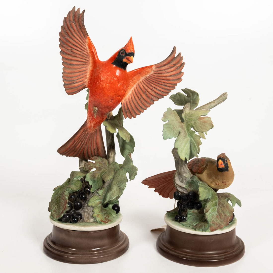 Pair of Boehm Bisque Porcelain Cardinals: Pair of Boehm Bisque Porcelain Cardinals, 20th Century Comprising of a male with open wings and a female, both among grapes and leaves. Christies Sale 544; Into the collection of a Northeast Ohio coll