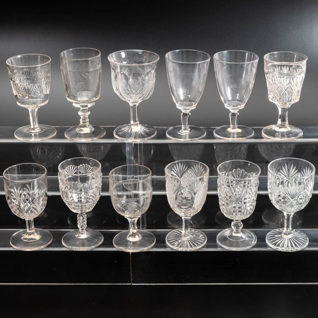 12 EAPG Pressed Glass Goblets: Twelve American Pressed Glass Goblets, 19th/20th Century, Having two, three (tri-mold) and four mold joints. Comprising: Sunken Daisy, 1890; Shell, 1880s; Parrot, 1870s; Majestic, 1885-93; Block and I