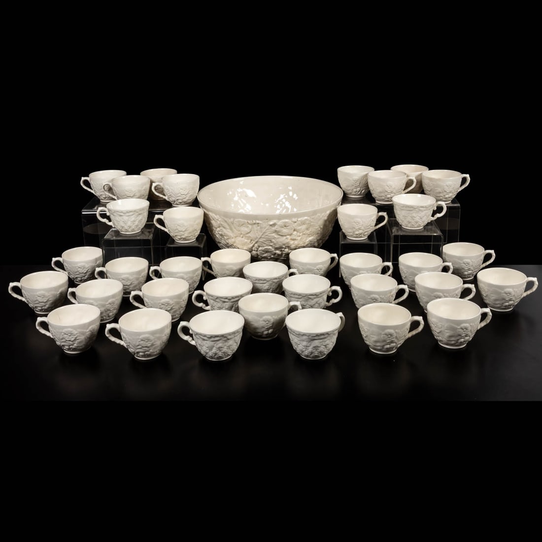 Spode Embossed Punch Set: A White Spode Embossed Punch Set, 20th Century Set of 36 cups and one punch bowl, made in England. Bowl dims.: H: 6 x Dia:12 1/2 in. The collection of an Ohio family.