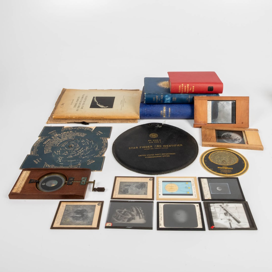 Astronomy slide rules, books, and magic lantern slides.: Set of 5 books on the sun, moon, and astronomy. Set of 3 slide rule star finders. Set of 10 magic lantern slides of moon, sun spots... Books include: GUILLEMIN, A. (1826-1893), The Heavens (1867);