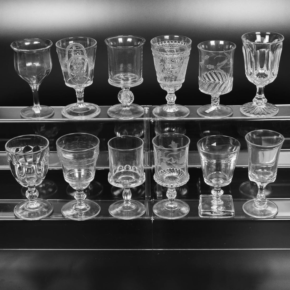12 EAPG Pressed Glass Goblets: Twelve American Pressed Glass Goblets, 19th-20th Centuries, Having two, three (tri-mold) or four mold joints. Patterns Comprising: Flare Top Hexagon Flute, late 19th century; Cupid and Venus, 1875; Go