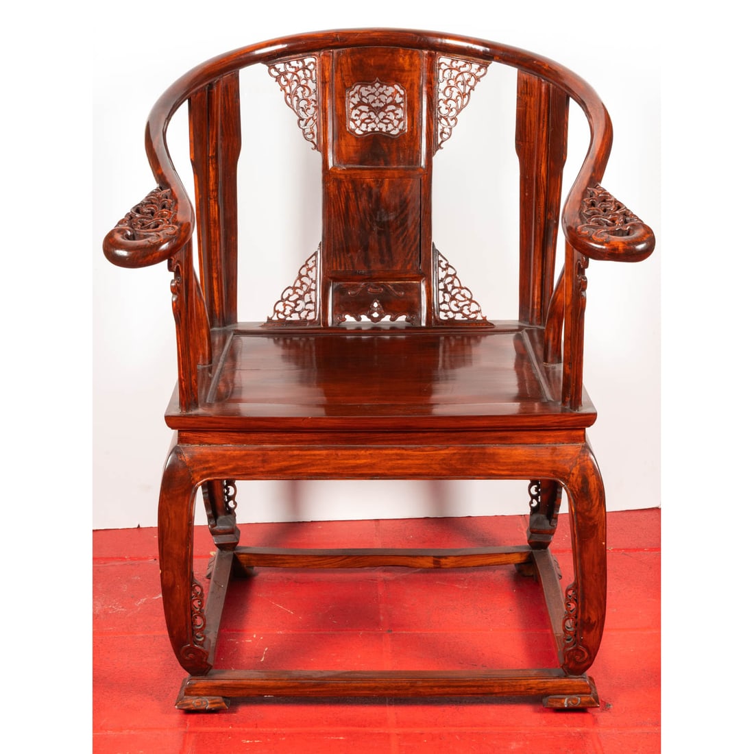 A Chinese Carved Elm Armchair: A Chinese Carved Elm Armchair, 20th Century, In the Qing style. H: 39 W: 30 D: 25 in.