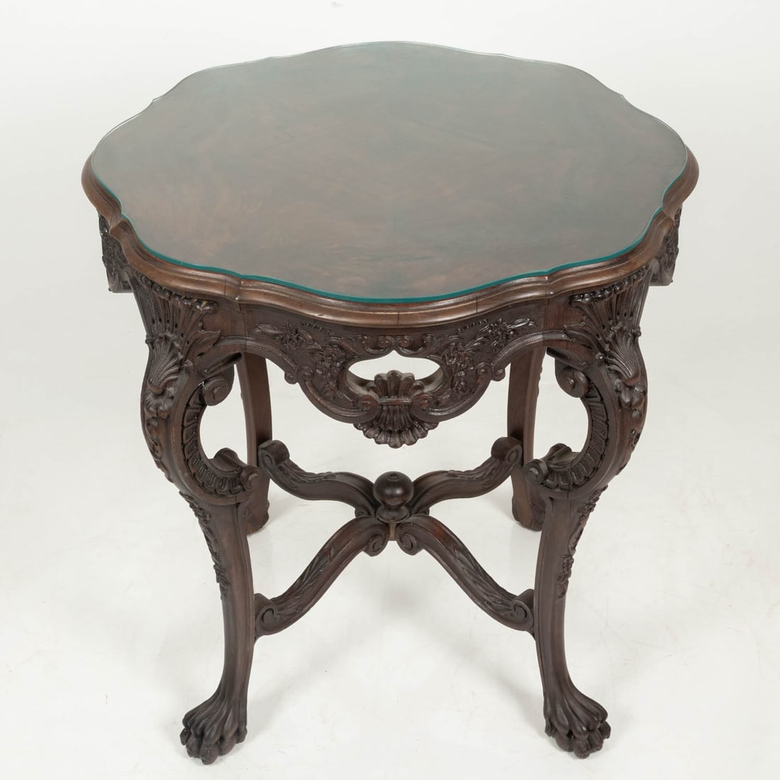 A Rococo Style Carved Hardwood Center Table: A Rococo Style Carved Hardwood Center Table, 20th Century, With glass top. H: 29 W: 28 1/4 D: 28 in.