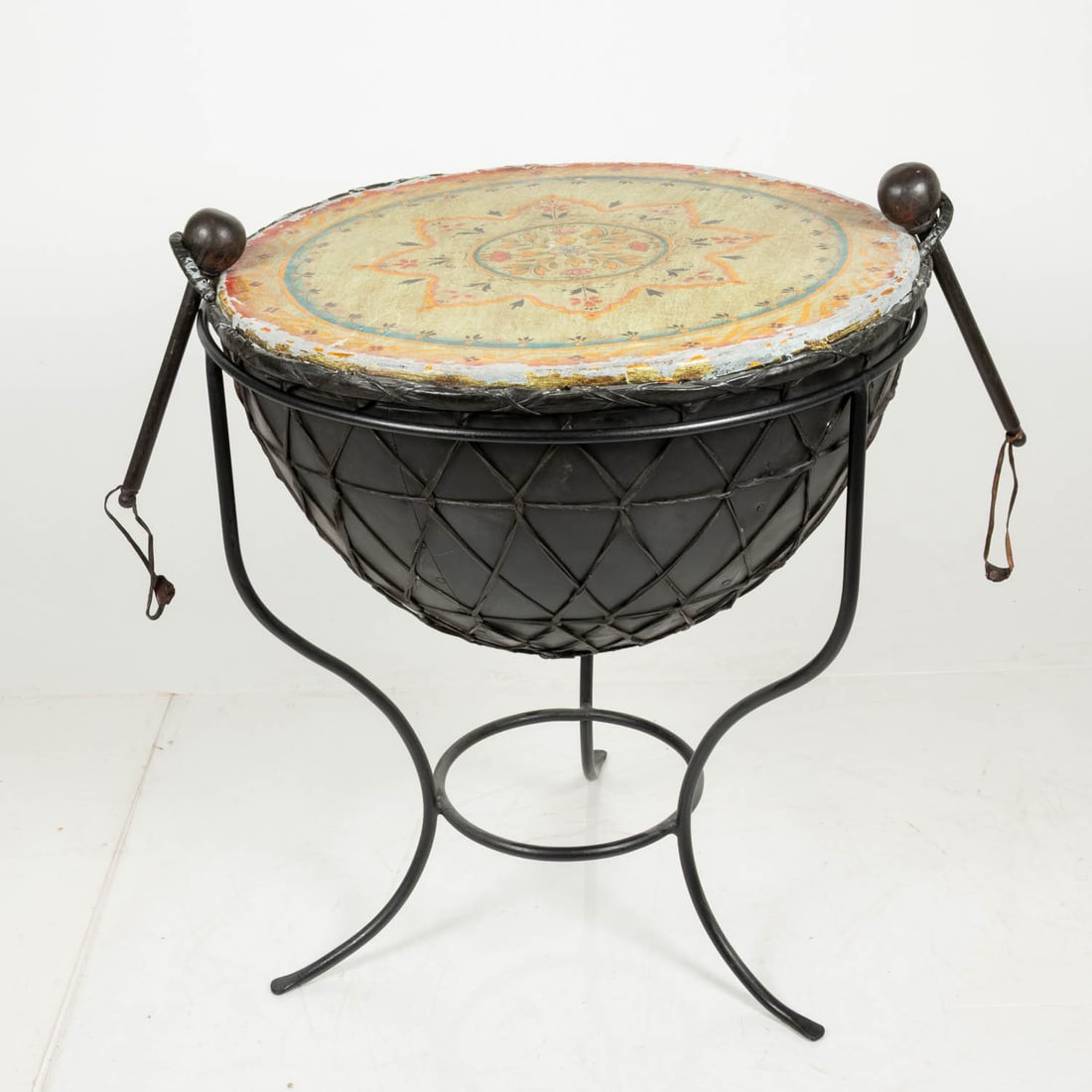 Indian Painted Leather and Wrought Iron Kettle Drum: Indian Painted Leather and Wrought Iron Kettle Drum, 20th Century. With base: H: 34 1/2 x W: 31 x D: 28 in. 2 drumsticks: L: 13 in.