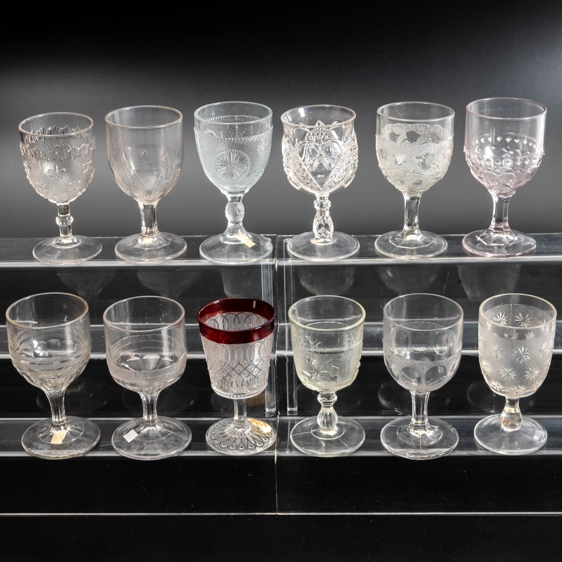 12 EAPG Pressed Glass Goblets: Twelve American Pressed Glass Goblets, 19th/20th Century, Having two, three (tri-mold) or four mold joints. Comprising: Dart, 1860s; Heart with Thumbprint, 1899; Birch, 1890s; Stippled Ivy, 1875; Stip