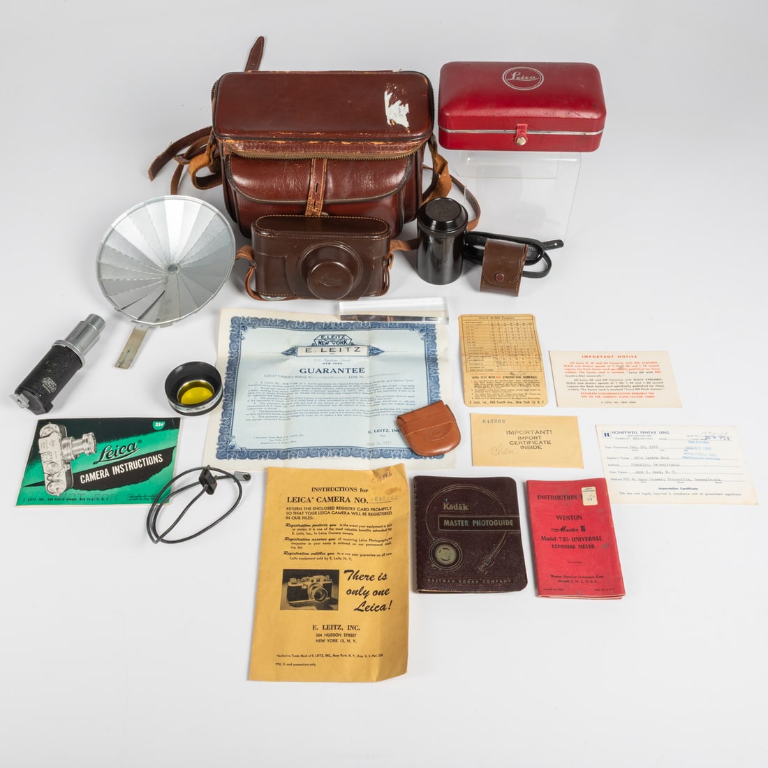 A Vintage Leica IIIf Camera with Accessories: A Vintage Leica IIIf Camera #642262, ca. 1953, German DRP Ernest Leitz Wetzlar GmbH With Summitar F=5cm 1:2 lens no. 860319. Together with a Wollensak 90mm 4.5 Raptar lens no. 542956 and a plastic cas